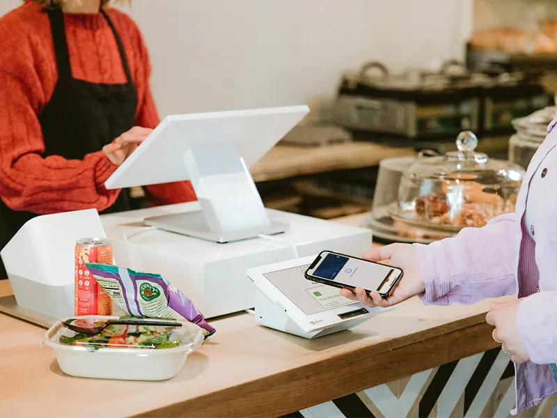 Merchant using the Roc Terminal+ mobile app on a tablet to send a digital invoice to a customer.